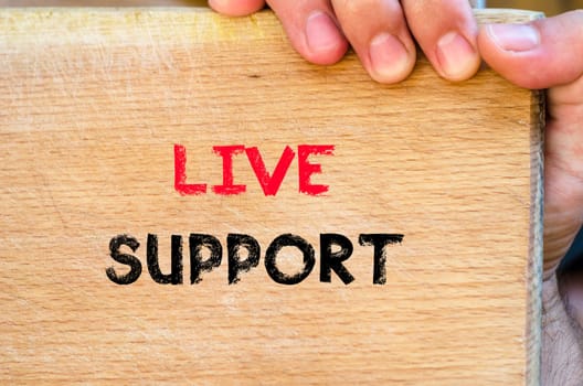 Live support text concept with human hand over wooden background