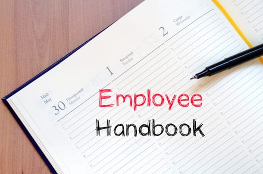 Employee handbook text concept write on notebook