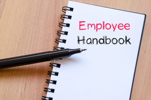 Employee handbook text concept write on notebook
