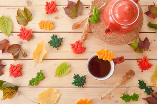 Hot tea and colorful cookies in autumn