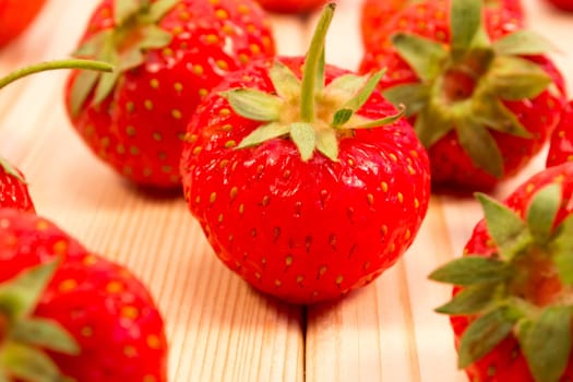 Strawberries scattered on wooden table