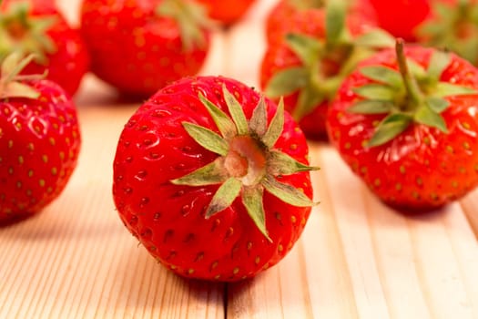 Strawberries scattered on wooden table