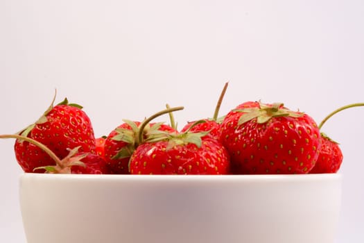 Strawberry in the ball on the wodden table and white background