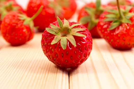 Strawberries scattered on wooden table
