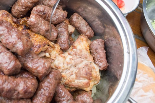 Bowl full with grilled meat. Pork chops, cevapcici