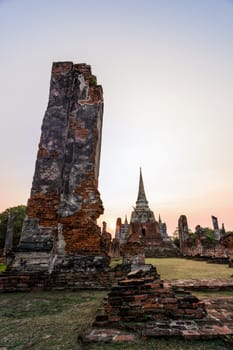 Ruins and pagoda ancient architecture of Wat Phra Si Sanphet old temple famous attractions during sunset at Phra Nakhon Si Ayutthaya Historical Park in Ayutthaya Province, Thailand