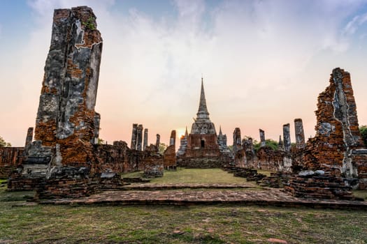 Ruins and pagoda ancient architecture of Wat Phra Si Sanphet old temple famous attractions during sunset at Phra Nakhon Si Ayutthaya Historical Park in Ayutthaya Province, Thailand
