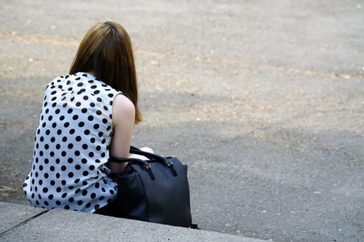 Teenager sits on a staircase