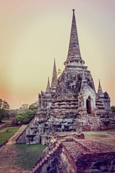 Vintage style add texture effect, ancient ruins and pagoda of Wat Phra Si Sanphet old temple famous attractions during sunset at Phra Nakhon Si Ayutthaya Historical Park, Ayutthaya Province, Thailand