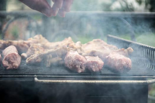 Grilling cevapi and pork chops.