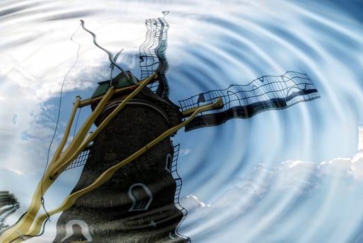 Windmill is reflected in the water with wavy water rings