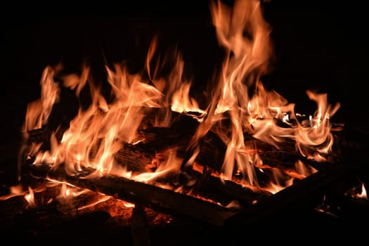 big wooden campfire at night