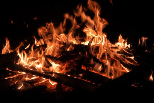 big wooden campfire at night