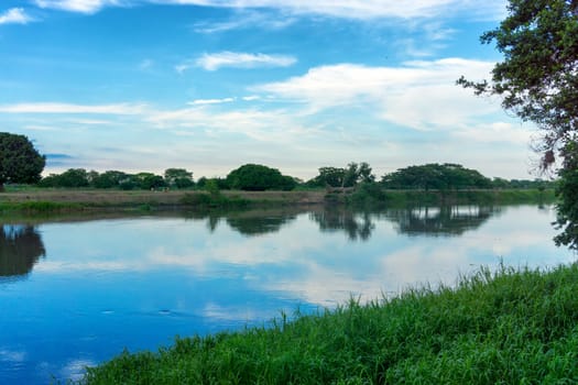 View of the Magdalena River with a beautiful reflection in Mompox, Colombia