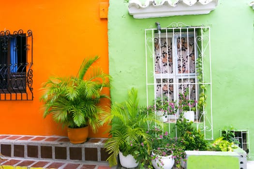 Beautiful green and orange colonial architecture with lush green plants in Cartagena, Colombia