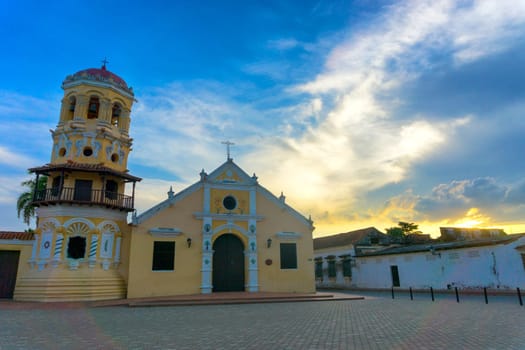 Beautiful Santa Barbara church with a dramatic sky at sunset in Mompox, Colombia