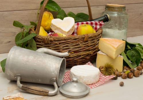 the french cheeses with a basket of apples