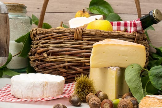the french cheeses with a basket of apples