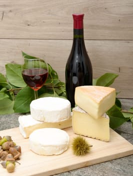 the french cheese with a glass and a bottle of wine