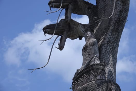 Buddhist figure made of stone,huge spiritual sculpture with seven snakes