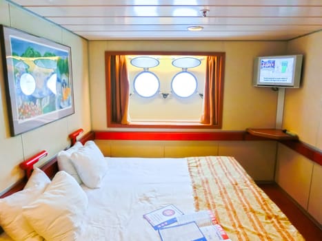 San Juan, Puerto Rico - May 08, 2016: The inside cabin with two portholes at Carnival Cruise Ship Fascination. She is one of 8 sister ships and received a million dollar refurbishment in 2006