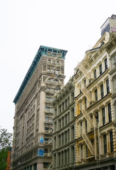 New York City, United States of America - May 02, 2016: The old residential buildings with fire escape stairs in Soho, New York City