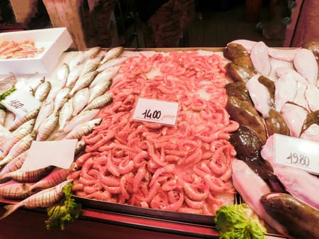Venetian fish market - fish and prawns. The Rialto fish market is located alongside the Grand Canal near the Rialto Bridge - Venice, Italy