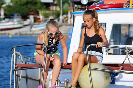 Nessebar, Bulgaria - July 16, 2016:  Two Young Girls Sitting in a Boat, Sailing Between Nessebar and Sunny Beach on the Coast of the Black Sea in Bulgaria..
