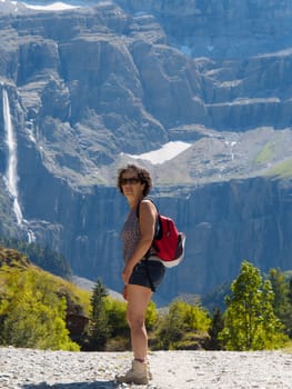 A woman hiker and cirque de Gavarnie in the French pyrenees