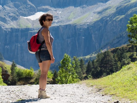 A woman hiker and cirque de Gavarnie in the French pyrenees