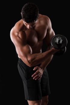 Portrait of a muscular man lifting weights against a dark background