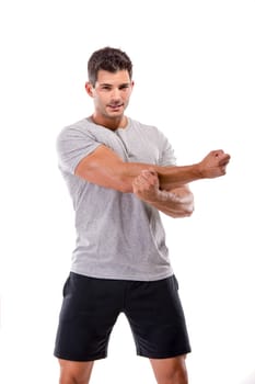 Athletic man doing some warming exercises, isolated over a white background