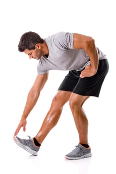 Athletic man doing some warming exercises, isolated over a white background