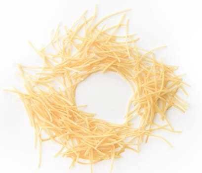 Small dry pasta noodles on white background