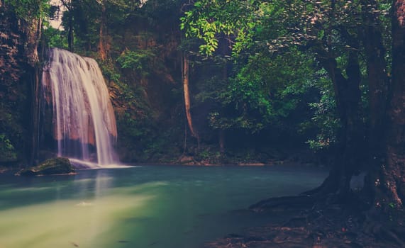 Tropical rainforest waterfall in Kanchaburi, Thailand. Vintage filtered effect image