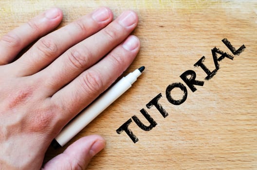Human hand over wooden background and tutorial text concept