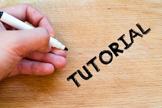 Human hand over wooden background and tutorial text concept