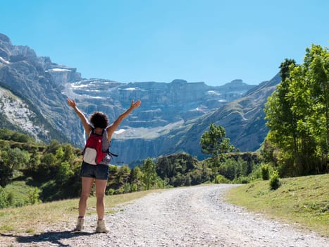 A woman hiker and cirque de Gavarnie in the French pyrenees mountains