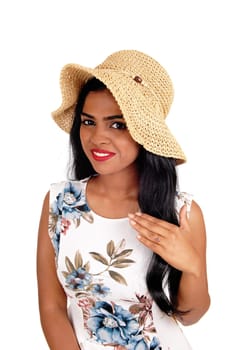A beautiful woman with a beige straw hat and long black hair looking .into the camera, isolated for white background..