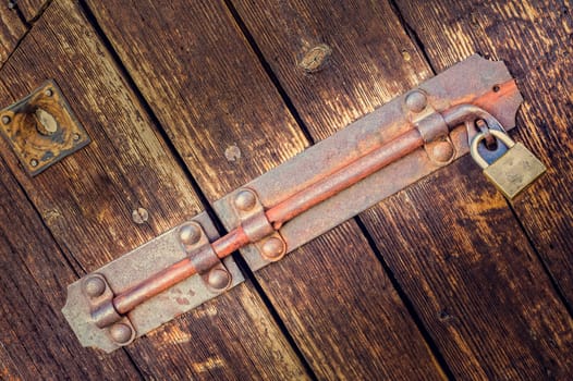 Old latch of a old wooden door .