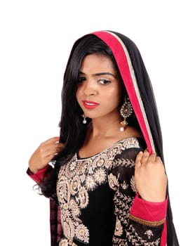 A gorgeous young Indian woman in a original Indian dress and long black.hair standing in front, isolated for white background..