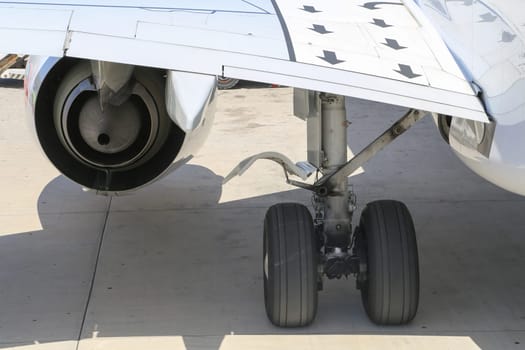 Close up of aircraft wheel and engine at the tarmac