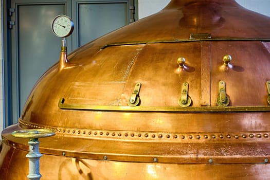 Traditional copper distillery tanks in a beer brewery