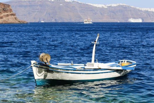 Clear turquoise water with an empty fishing boat