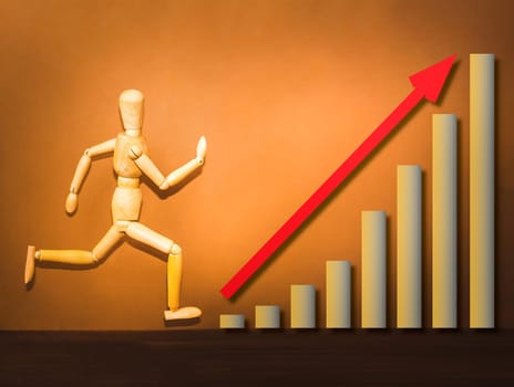 The wooden figure running on stairs of business plan on brown background. business concept of achievement