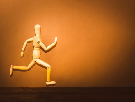 The figure of wooden man, running on wooden background