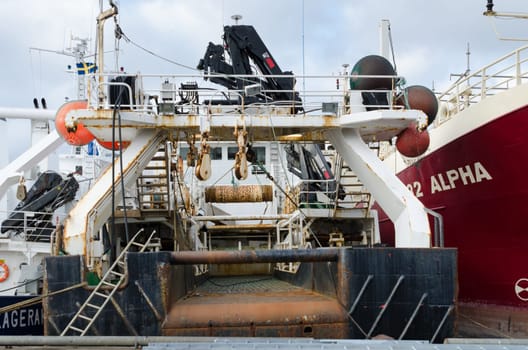 back of a big fishingboat in the harbour ready to go out to the ocean