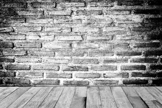 empty room with red brick wall and wooden floor