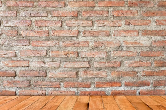 empty room with red brick wall and wooden floor