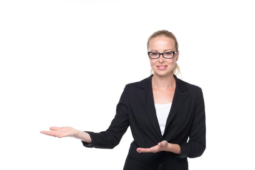 Beautiful young businesswoman smiling, holding open palm with empty copy space. Business woman showing hand sign to side, concept of advertisement product. White background.
